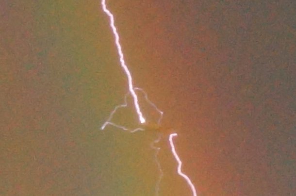 Amazing photo shows lightning striking an airliner flying in a rainbow - Boeing777-D-AALB_1