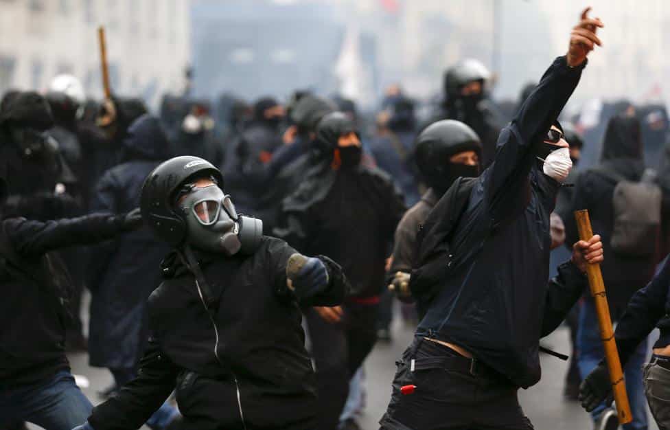 Protesters throw objects during a rally against Expo 2015 in Milan, Italy