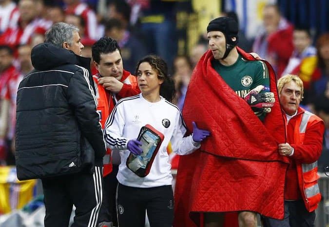 Chelsea's goal keeper Petr Cech walks past his manager Jose Mourihno as he is escorted off the pitch by the team doctor Eva Carneiro after being injured during their Champion's League semi-final first leg soccer match against Atletico Madrid at Vicente Calderon stadium in Madrid, April 22, 2014. REUTERS/Darren Staples (SPAIN - Tags: SPORT SOCCER)