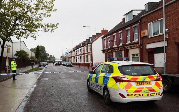 The scene in Wallasey, Merseyside, after a policeman was mown down and killed by a stolen car. PRESS ASSOCIATION Photo. Picture date: Monday October 5, 2015. The officer was standing on a central reservation when the stolen Mitsubishi car, being pursued by police following a burglary, mounted the kerb and hit him at speed before driving off, Merseyside Police said. See PA story POLICE Car. Photo credit should read: Billy Griffiths/PA Wire